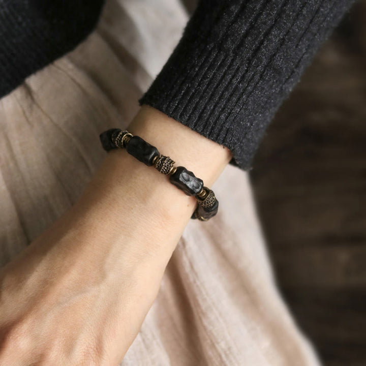 Pulsera de paz tranquila de cobre y madera de ébano tibetano con Buddha Stones