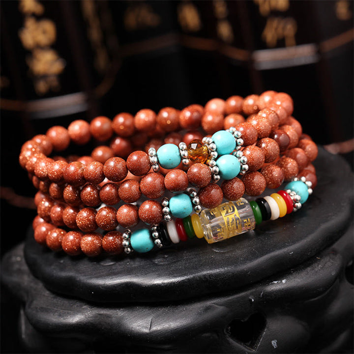 Buddha Stones 108 cuentas Mala Goldstone Om Mani Padme Hum esvástica pulsera de confianza