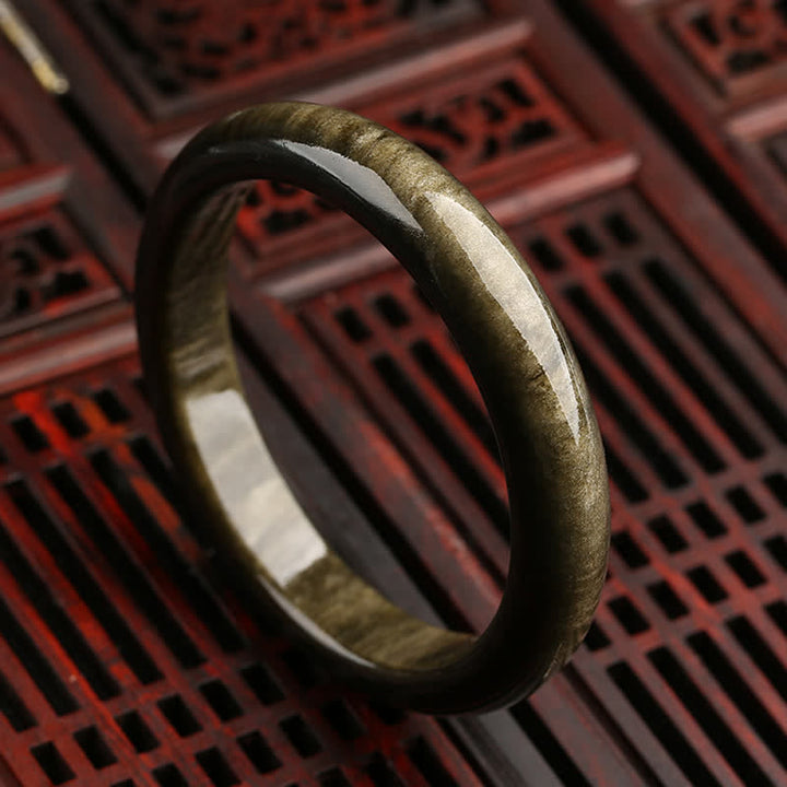 Brazalete de protección de obsidiana con brillo dorado y Buddha Stones