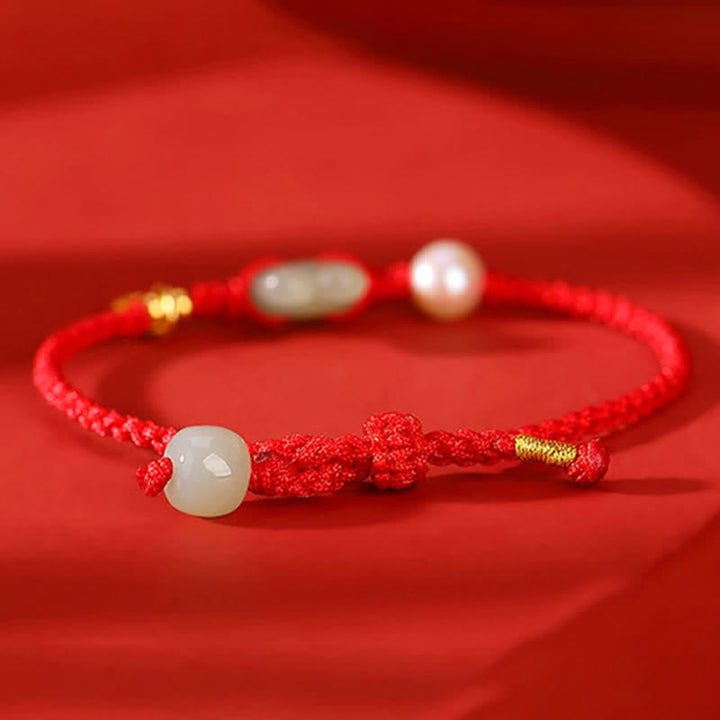 Pulsera de hilo rojo con moneda de cobre y jade hetiano del año del conejo en plata de ley 925