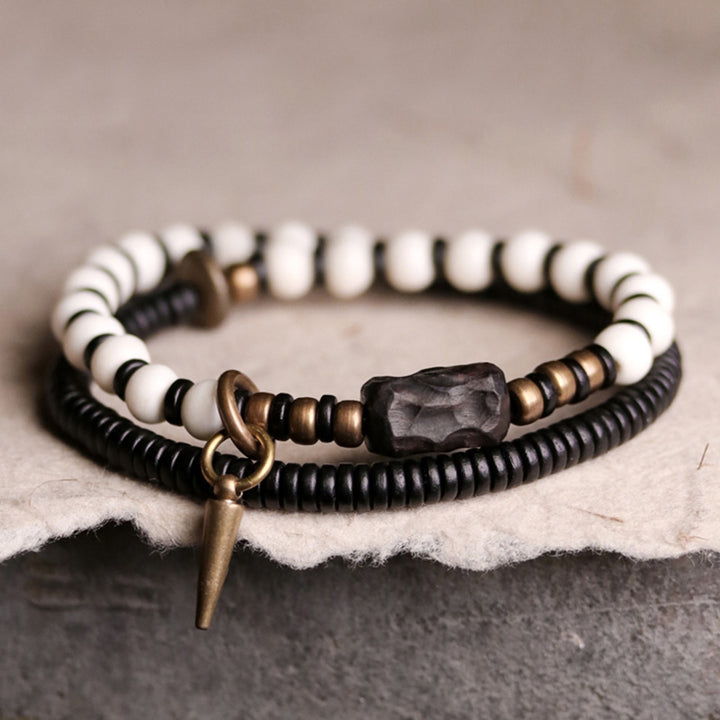 Pulsera de pareja con Buddha Stones, cuentas de hueso, madera de ébano y cobre.