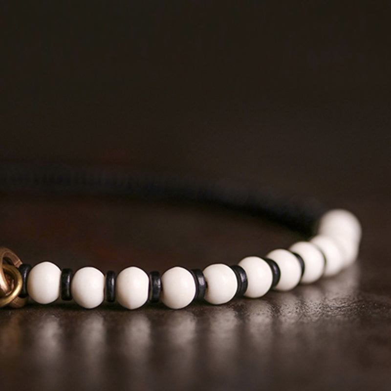 Pulsera de pareja con Buddha Stones, cuentas de hueso, madera de ébano y cobre.