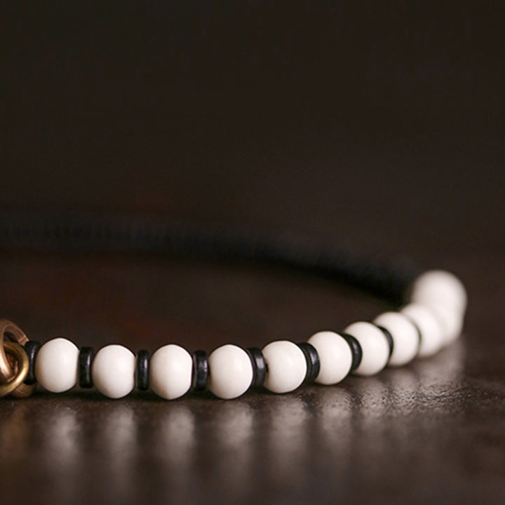 Pulsera de pareja con Buddha Stones, cuentas de hueso, madera de ébano y cobre.