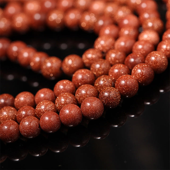 Buddha Stones 108 cuentas Mala Goldstone Om Mani Padme Hum esvástica pulsera de confianza