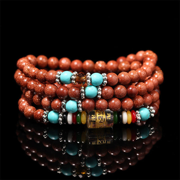 Buddha Stones 108 cuentas Mala Goldstone Om Mani Padme Hum esvástica pulsera de confianza