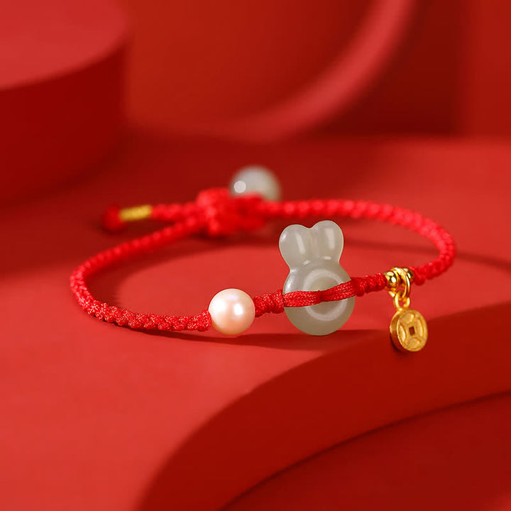 Pulsera de hilo rojo con moneda de cobre y jade hetiano del año del conejo en plata de ley 925