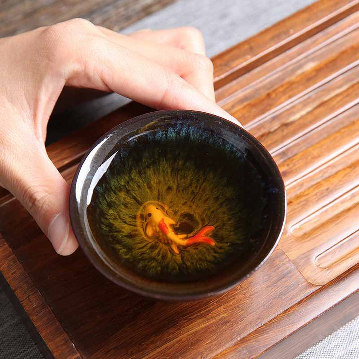Buddha Stones, pequeño pez Koi, cambio de horno azul, taza de té de cerámica china Jianzhan, taza de té de Kung Fu 75ml