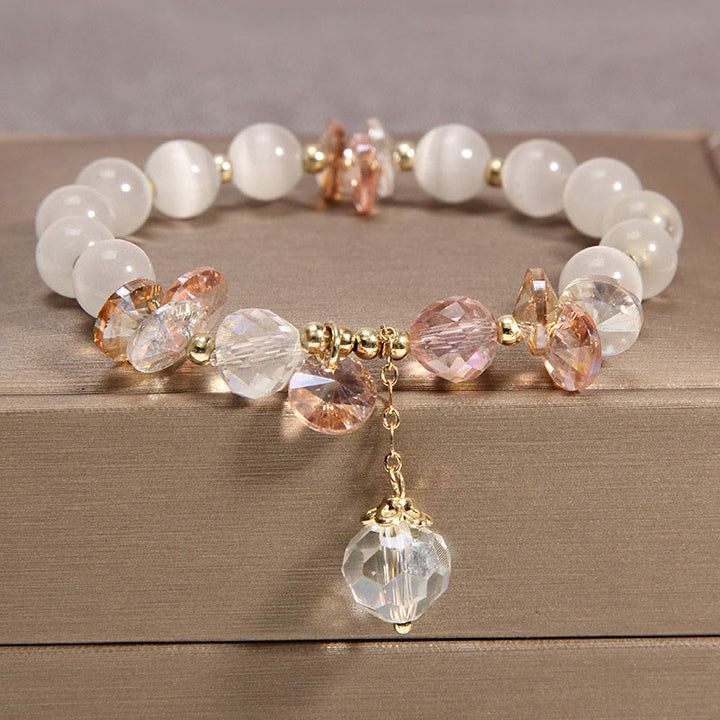 Pulsera con dije de paz y cristal rosa con ojo de gato y Buddha Stones