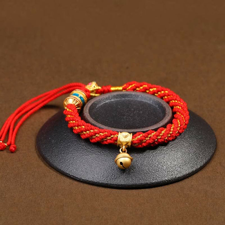 Pulsera de cuerda trenzada con dije de campana y rueda de oración Thangka de protección de la suerte hecha a mano tibetana