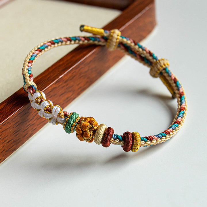 Pulsera de hilo trenzado con diseño de flor de melocotón de color Dunhuang hecha a mano con Buddha Stones