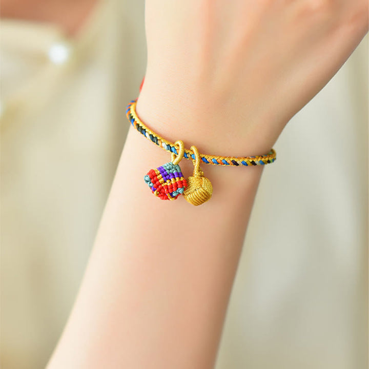 Pulsera con dije de bola dorada Zongzi hecha a mano con cuerda colorida y Buddha Stones