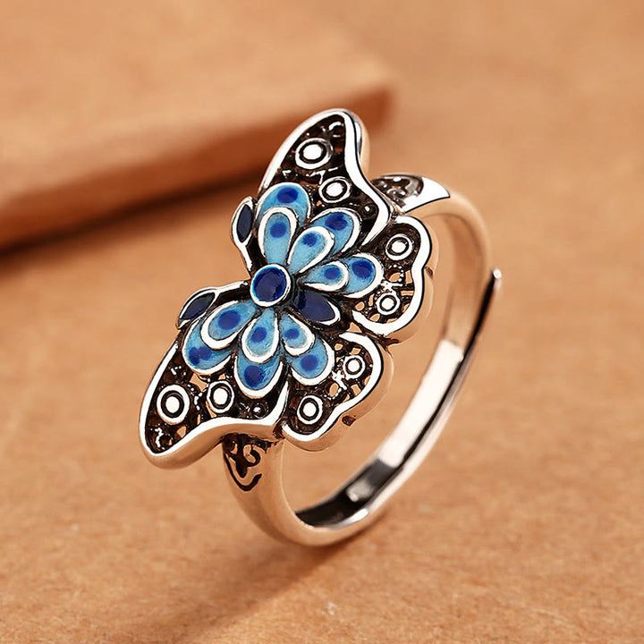 Anillo de amor con patrón de mariposa azul esmaltado hueco con Buddha Stones