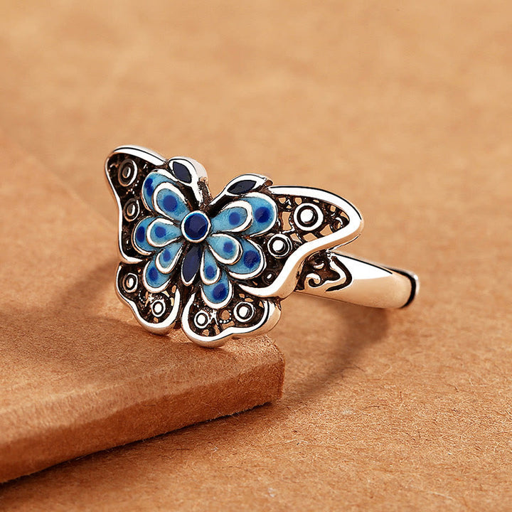 Anillo de amor con patrón de mariposa azul esmaltado hueco con Buddha Stones