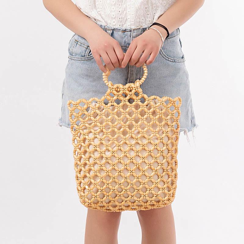 Bolso de cuentas de madera huecas tejidas a mano con hilo de pesca tejida y piedras de Buda