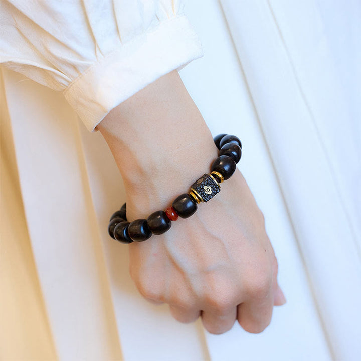 Pulsera de calma grabada en madera de ébano con nubes auspiciosas y Buddha Stones