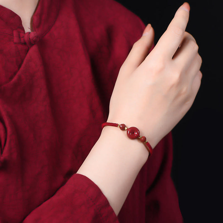 Buddha Stones Pulsera tejida a mano de cinabrio con hebilla de paz de loto, bendición y calma