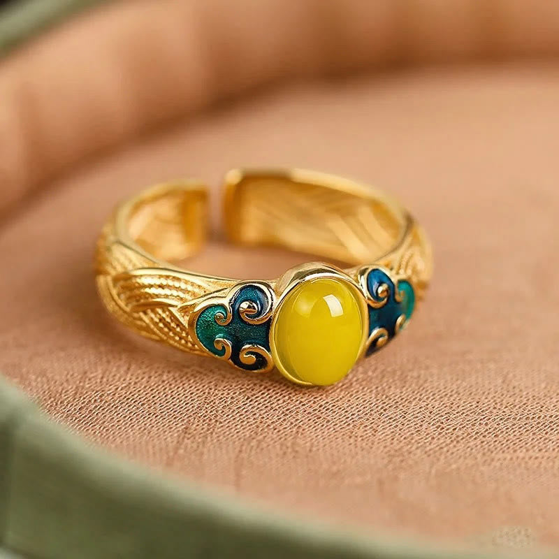 Anillo ajustable con nubes auspiciosas de cobre y ámbar con Buddha Stones