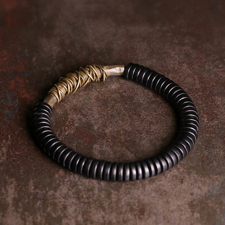 Pulsera de cobre y madera de ébano tibetano con Buddha Stones
