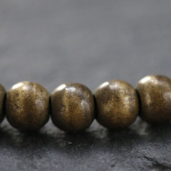 Pulsera sencilla de equilibrio de riqueza con cuentas de cobre y latón y Buddha Stones