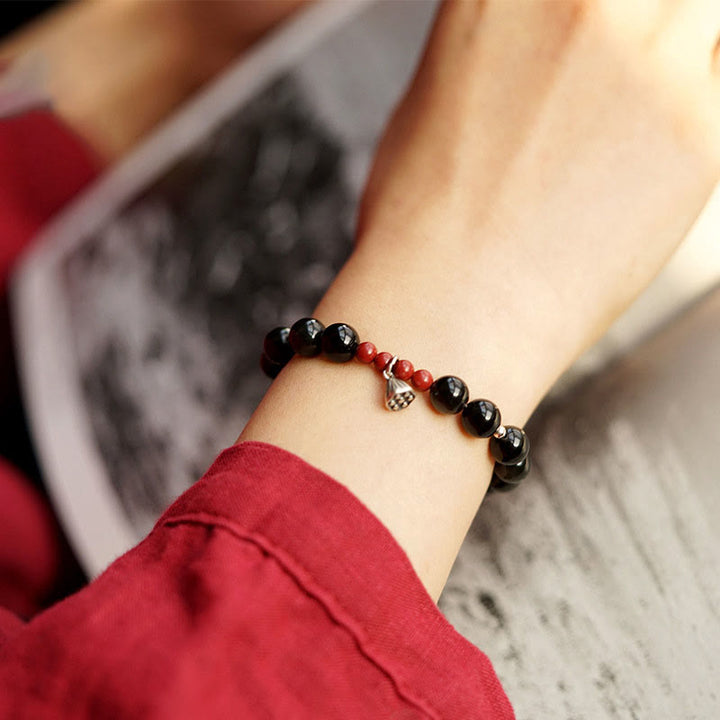 Pulsera de poder con dije de loto de cinabrio y obsidiana negra natural de Buddha Stones