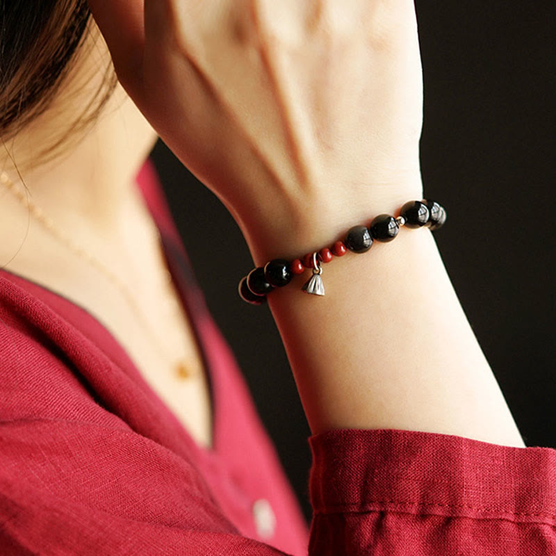 Pulsera de poder con dije de loto de cinabrio y obsidiana negra natural de Buddha Stones