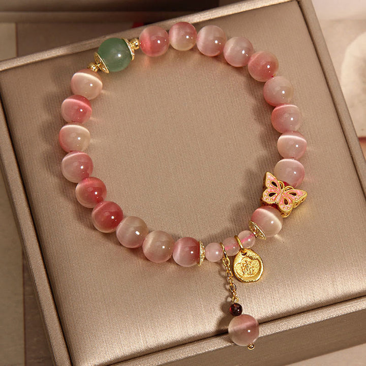 Pulsera de la paz con mariposa y ojo de gato en color rosa degradado con Buddha Stones