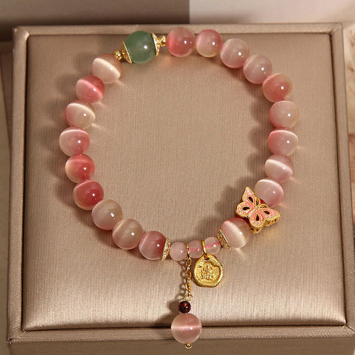 Pulsera de la paz con mariposa y ojo de gato en color rosa degradado con Buddha Stones