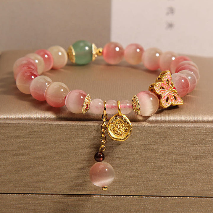 Pulsera de la paz con mariposa y ojo de gato en color rosa degradado con Buddha Stones
