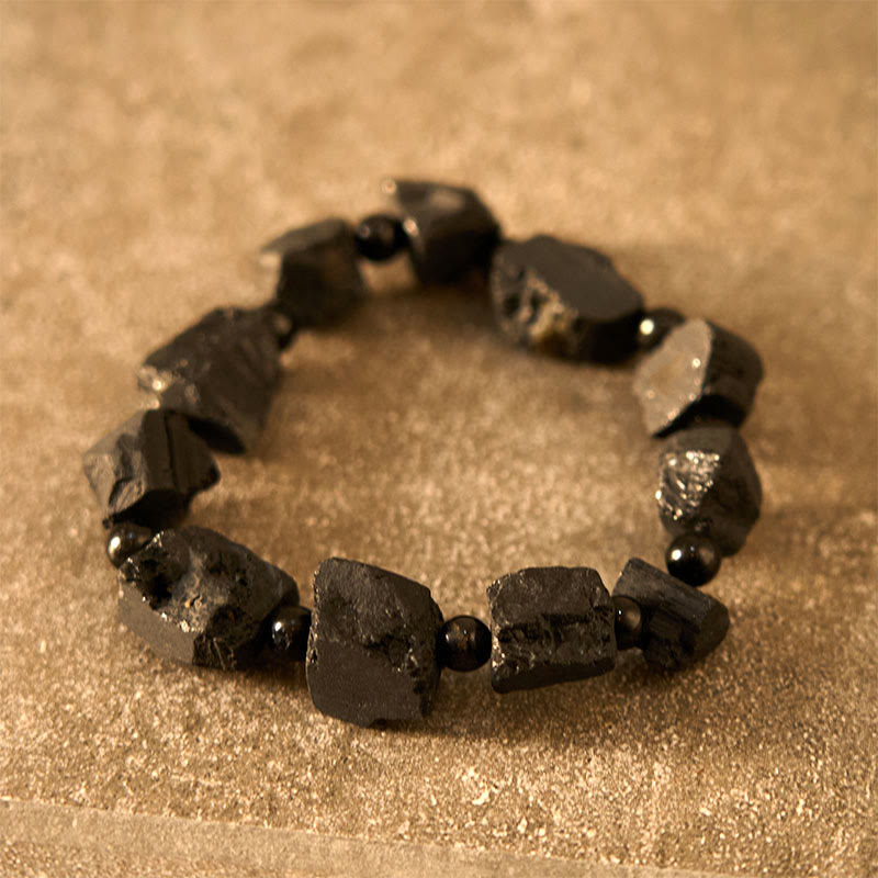Pulsera positiva con piedra irregular de turmalina negra y Buddha Stones