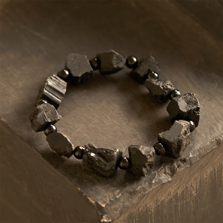 Pulsera positiva con piedra irregular de turmalina negra y Buddha Stones