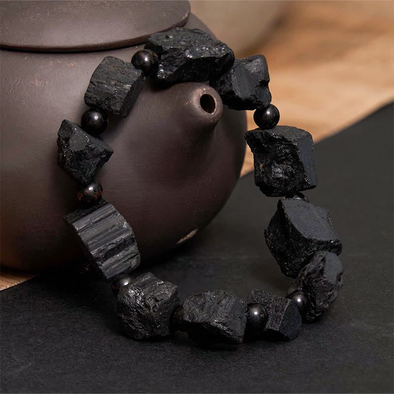 Pulsera positiva con piedra irregular de turmalina negra y Buddha Stones