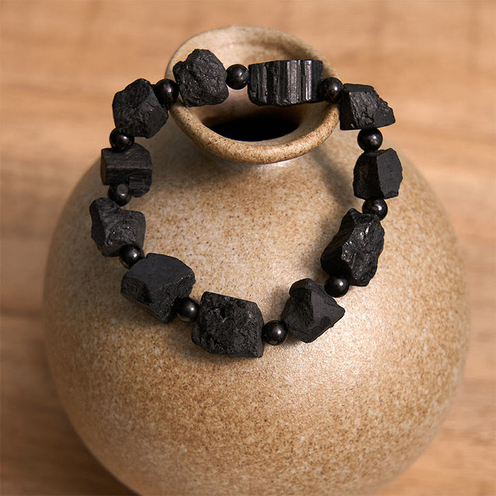 Pulsera positiva con piedra irregular de turmalina negra y Buddha Stones