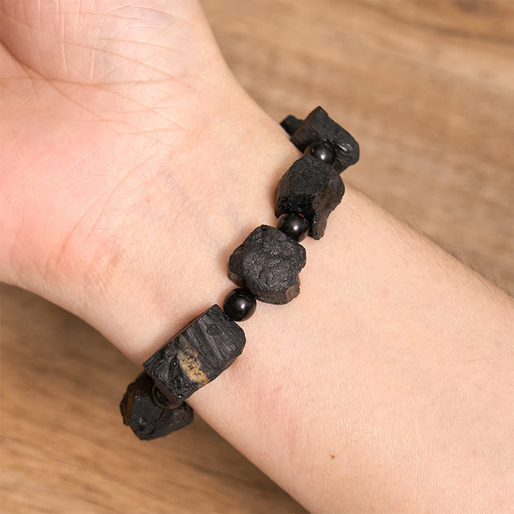 Pulsera positiva con piedra irregular de turmalina negra y Buddha Stones