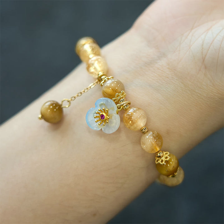 Pulsera de generosidad con dije de flor de ojo de tigre y citrino de Buddha Stones