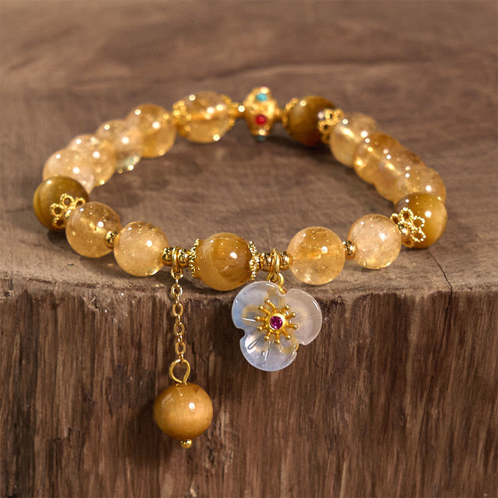 Pulsera de generosidad con dije de flor de ojo de tigre y citrino de Buddha Stones