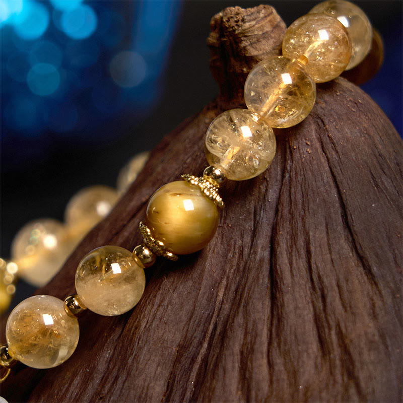Pulsera de generosidad con dije de flor de ojo de tigre y citrino de Buddha Stones