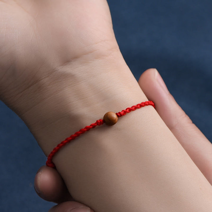 Pulsera trenzada con cuentas de madera de melocotón natural y Buddha Stones que alejan a los malos espíritus