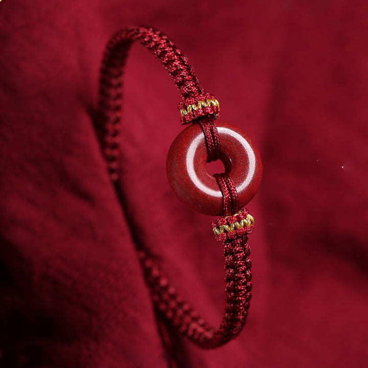 Pulsera trenzada de concentración con hebilla de paz redonda de cinabrio hecha a mano con Buddha Stones