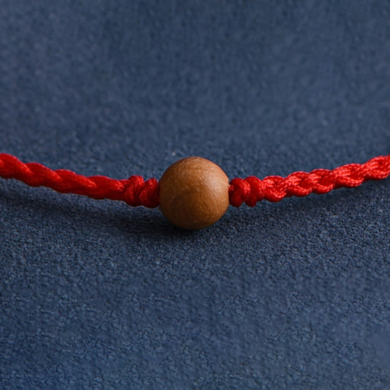 Pulsera trenzada con cuentas de madera de melocotón natural y Buddha Stones que alejan a los malos espíritus
