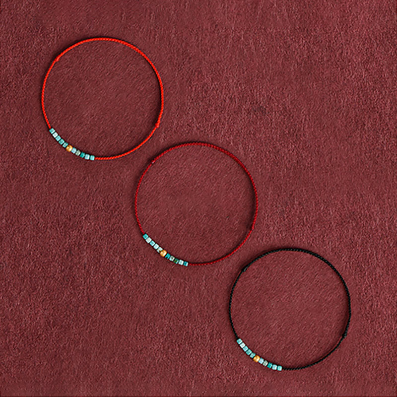 Pulsera trenzada con protección turquesa y cuentas de oro 999 de Buddha Stones
