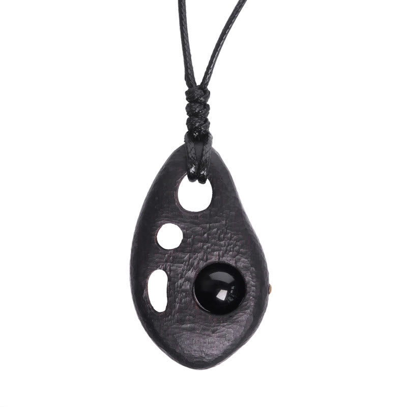 Collar con colgante de obsidiana hueca con incrustaciones de madera de ébano y Buddha Stones que transmiten paz y calma