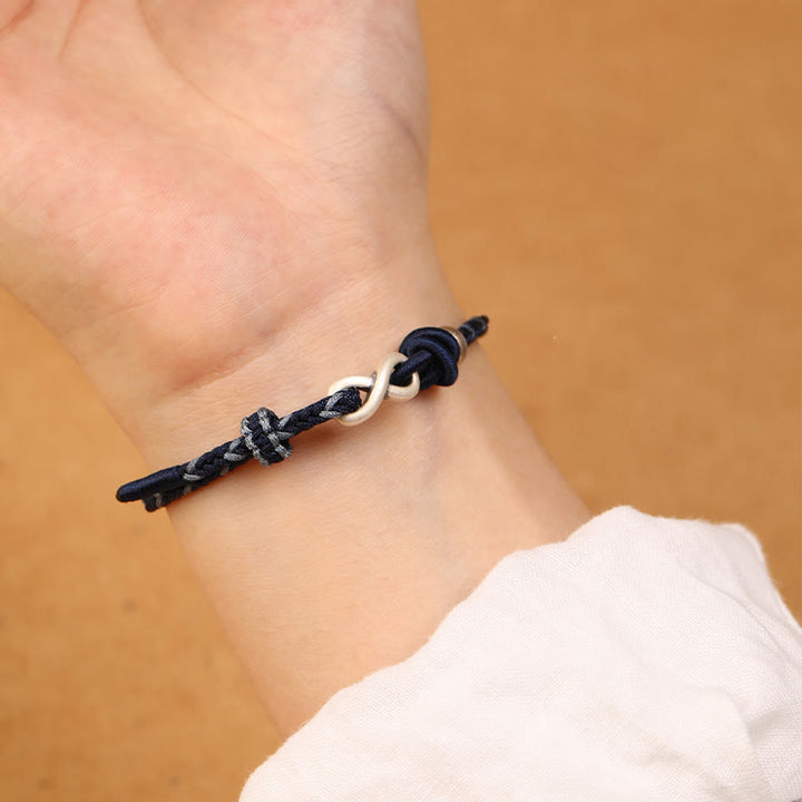 Pulsera de cuerda con símbolo de la suerte y nudo infinito hecha a mano en plata de ley 999 con Buddha Stones