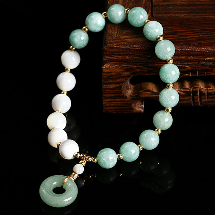 Pulsera con dije de paz y hebilla de caracol, herradura, trochus y Buddha Stones