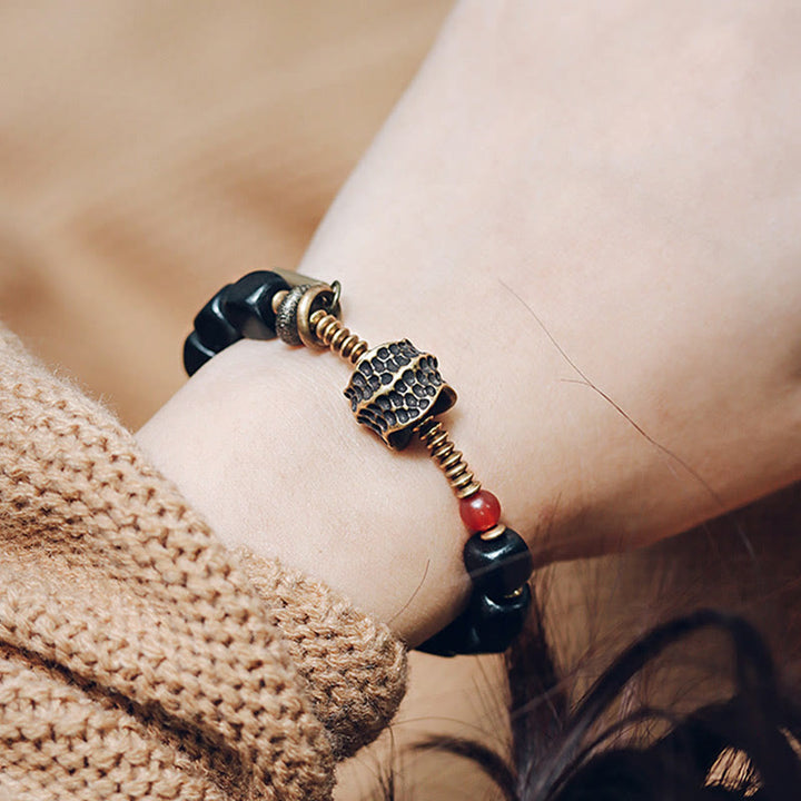 Pulsera de la paz con Buddha Stones, ébano, madera, cobre, latón y ágata roja