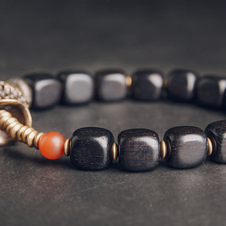 Pulsera de la paz con Buddha Stones, ébano, madera, cobre, latón y ágata roja