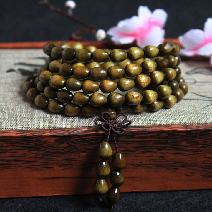 Pulsera de protección de madera natural Phoebe Zhennan con 108 cuentas en forma de lágrima y Buddha Stones