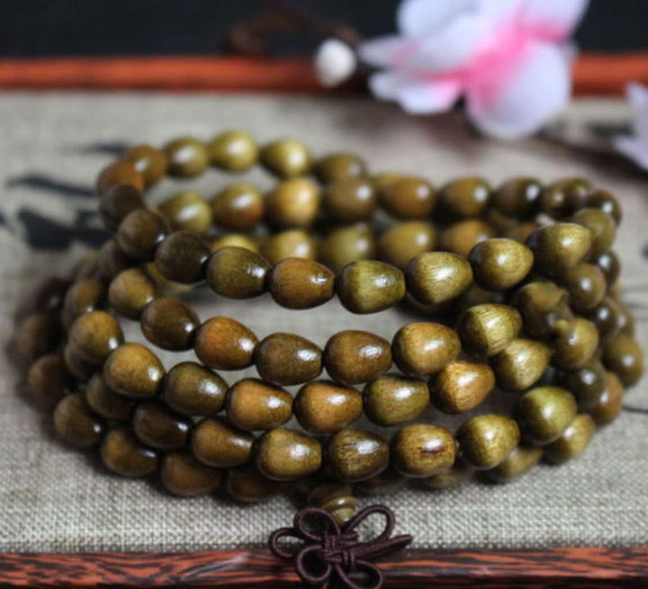 Pulsera de protección de madera natural Phoebe Zhennan con 108 cuentas en forma de lágrima y Buddha Stones