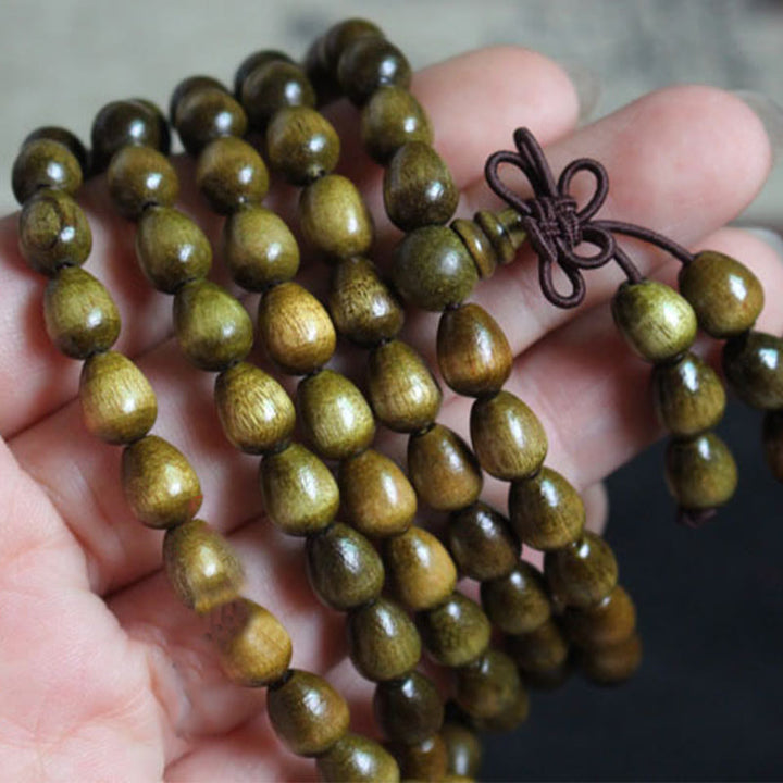 Pulsera de protección de madera natural Phoebe Zhennan con 108 cuentas en forma de lágrima y Buddha Stones