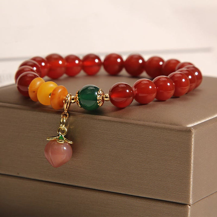 Pulsera de autoaceptación con dijes de melocotón, ámbar y ágata roja de Buddha Stones - image 2