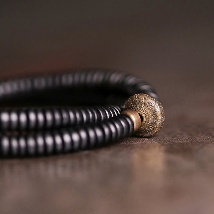 Pulsera de doble vuelta con Buddha Stones, madera de ébano, cobre y latón